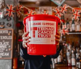 a person holding a donation bucket for Teenage cancer trust